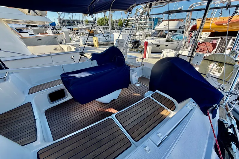 Slide: The Image of Cockpit of 2007 Jeanneau Sun Odyssey 49 DS sailboat with covered seating and teak flooring. - 27