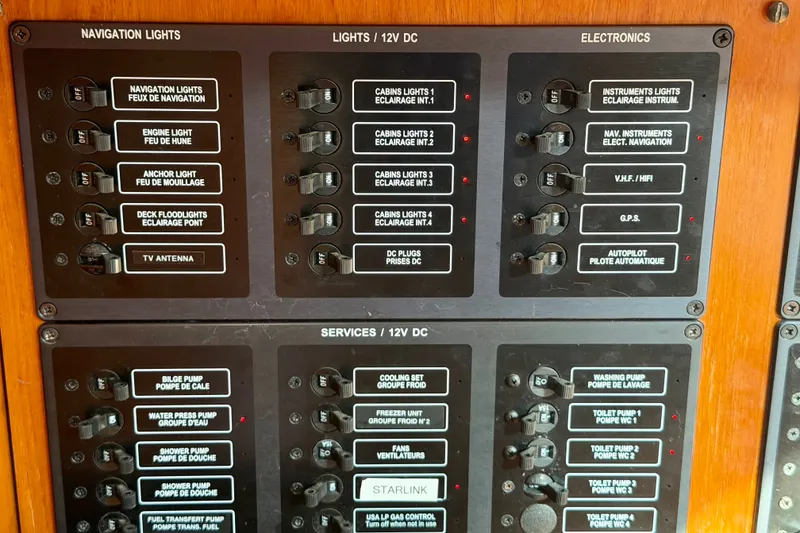 Slide: The Image of Control panel of a 2007 Jeanneau Sun Odyssey 49 DS yacht, featuring navigation and service switches. - 65