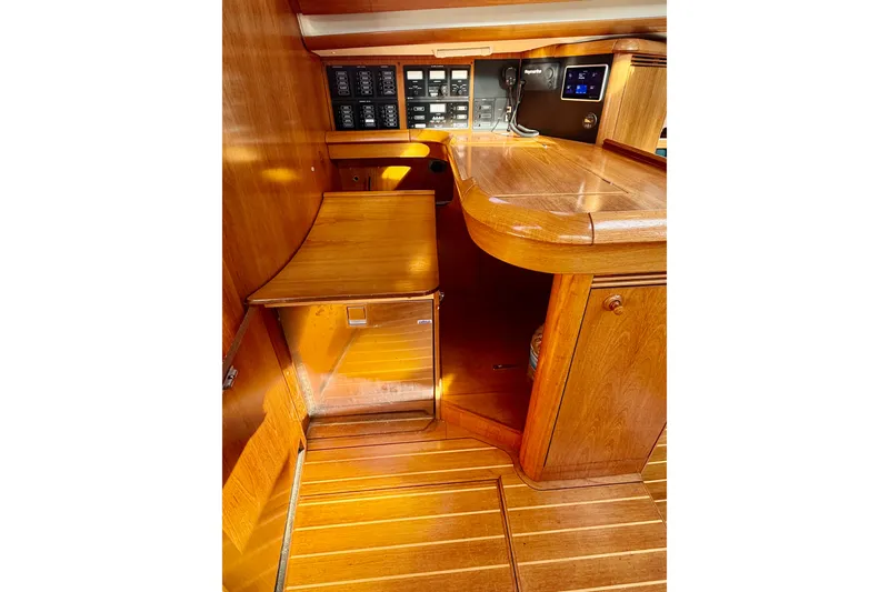 Slide: The Image of Interior of 2007 Jeanneau Sun Odyssey 49 DS yacht, featuring wooden cabinetry and control panels. - 95