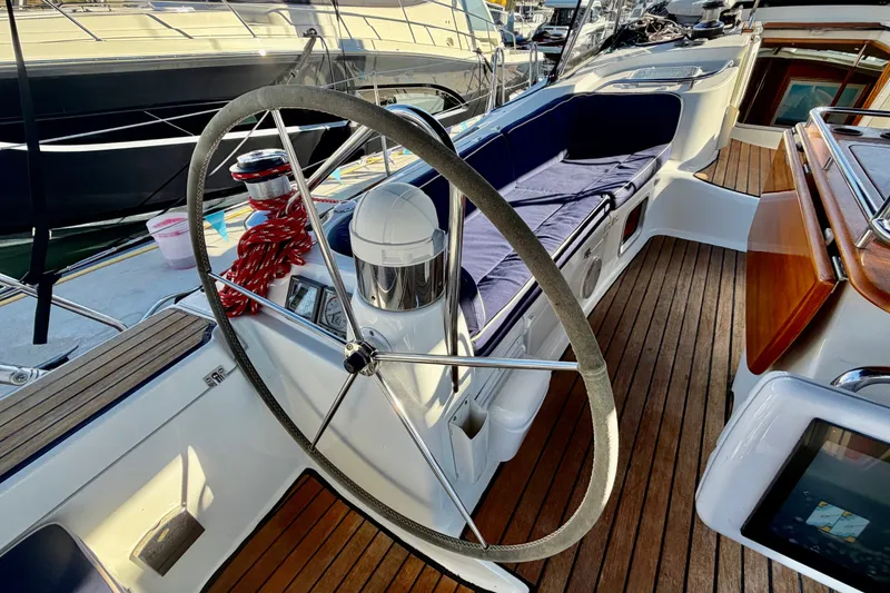 Slide: The Image of Cockpit of 2007 Jeanneau Sun Odyssey 49 DS sailboat with wooden deck and steering wheel. - 32