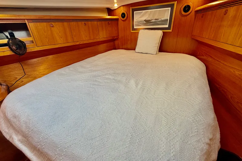 Slide: The Image of Cozy cabin interior of 2007 Jeanneau Sun Odyssey 49 DS with wooden finish and comfortable bedding. - 84