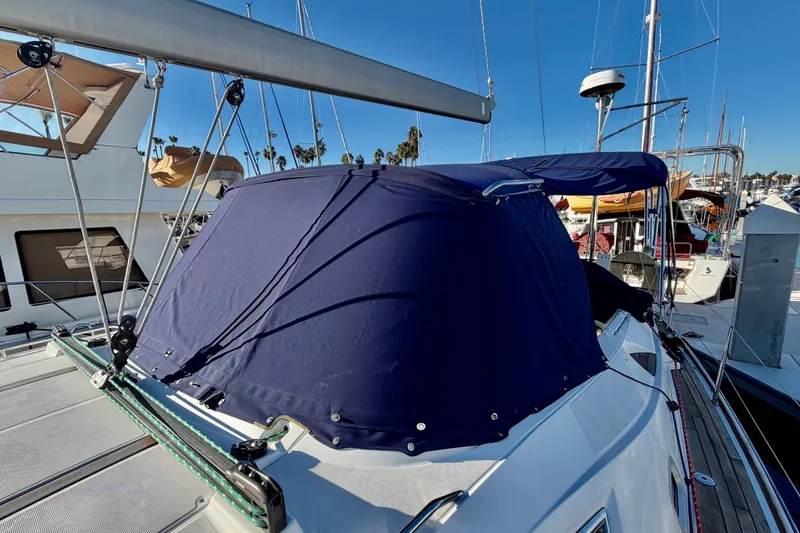 Slide: The Image of 2007 Jeanneau Sun Odyssey 49 DS sailboat with blue canvas cover at marina. - 26