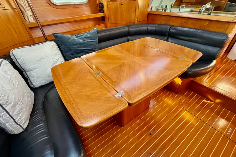 Slide: The Image of Luxurious interior of 2007 Jeanneau Sun Odyssey 49 DS with elegant wood table and seating. - 75