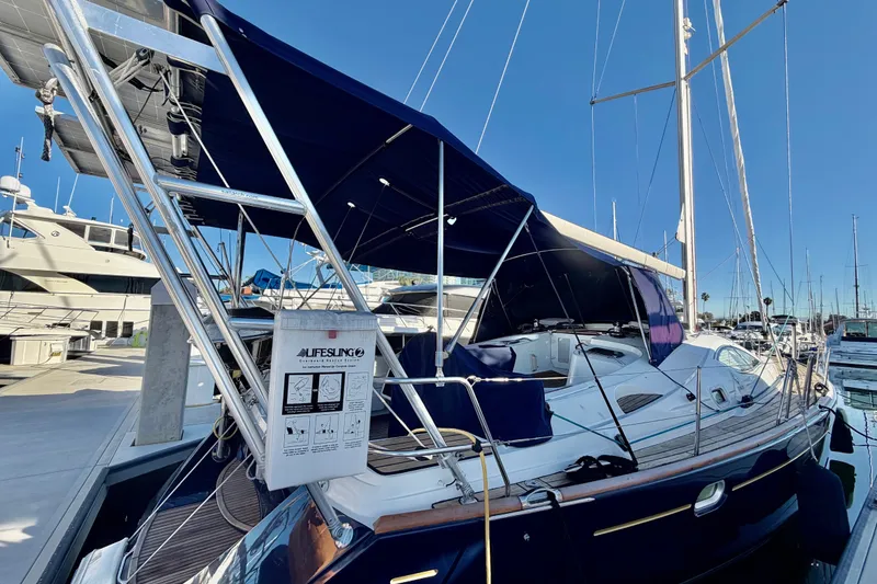 Slide: The Image of 2007 Jeanneau Sun Odyssey 49 DS sailboat docked at marina with blue canopy. - 10