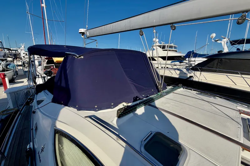 Slide: The Image of 2007 Jeanneau Sun Odyssey 49 DS sailboat with blue canopy docked at marina. - 17