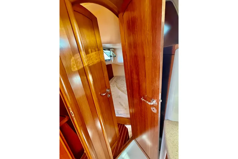 Slide: The Image of Interior view of 2007 Jeanneau Sun Odyssey 49 DS cabin with wooden door and cozy bed. - 97