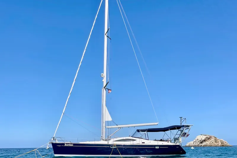 Slide: The Image of 2007 Jeanneau Sun Odyssey 49 DS sailboat anchored in clear blue waters. - 4
