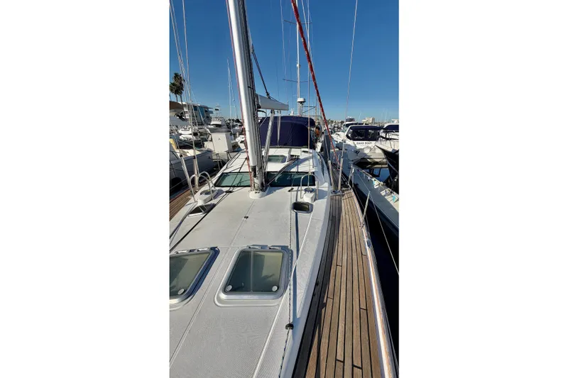 Slide: The Image of 2007 Jeanneau Sun Odyssey 49 DS sailboat docked at marina, showcasing sleek deck design. - 25
