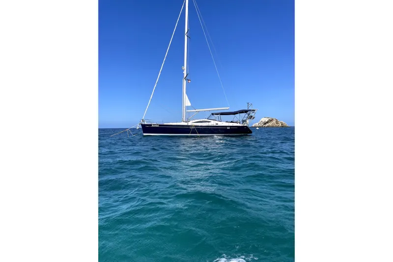 Slide: The Image of 2007 Jeanneau Sun Odyssey 49 DS sailboat on clear blue ocean waters. - 5