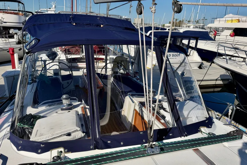 Slide: The Image of 2007 Jeanneau Sun Odyssey 49 DS sailboat docked at marina, featuring blue canopy and clear panels. - 40