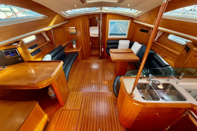Slide: The Image of Luxurious interior of 2007 Jeanneau Sun Odyssey 49 DS sailboat with wood finish and seating. - 72