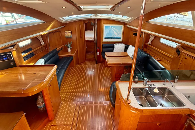 Slide: The Image of Luxurious interior of 2007 Jeanneau Sun Odyssey 49 DS sailboat with wood finish and seating area. - 93
