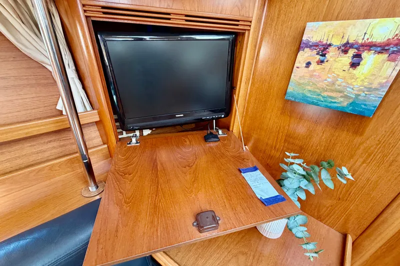 Slide: The Image of Interior of 2007 Jeanneau Sun Odyssey 49 DS with TV and artwork on wooden paneling. - 74