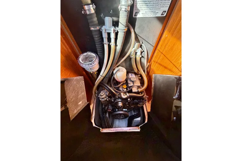 Slide: The Image of Engine compartment of 2007 Jeanneau Sun Odyssey 49 DS sailboat, showcasing hoses and components. - 103