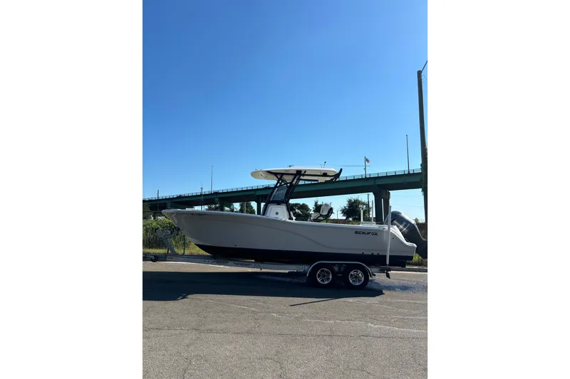 Slide: The Image of 2021 Sea Fox 248 Commander boat on trailer under clear blue sky. - 11