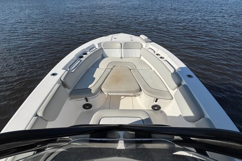 Slide: The Image of 2021 Sea Fox 248 Commander boat interior with cushioned seating on calm water. - 4