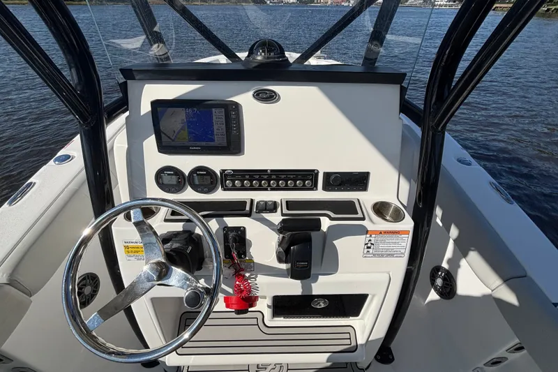 Slide: The Image of Control panel of a 2021 Sea Fox 248 Commander boat with steering wheel and navigation system. - 9