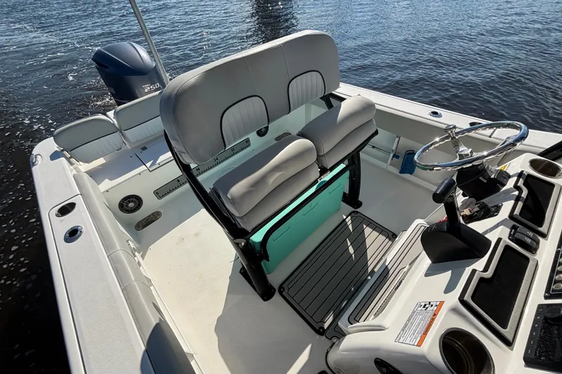 Slide: The Image of 2021 Sea Fox 248 Commander boat interior with helm, seating, and outboard motor on water. - 7