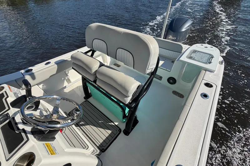 Slide: The Image of 2021 Sea Fox 248 Commander boat interior with dual seating and steering wheel on water. - 5