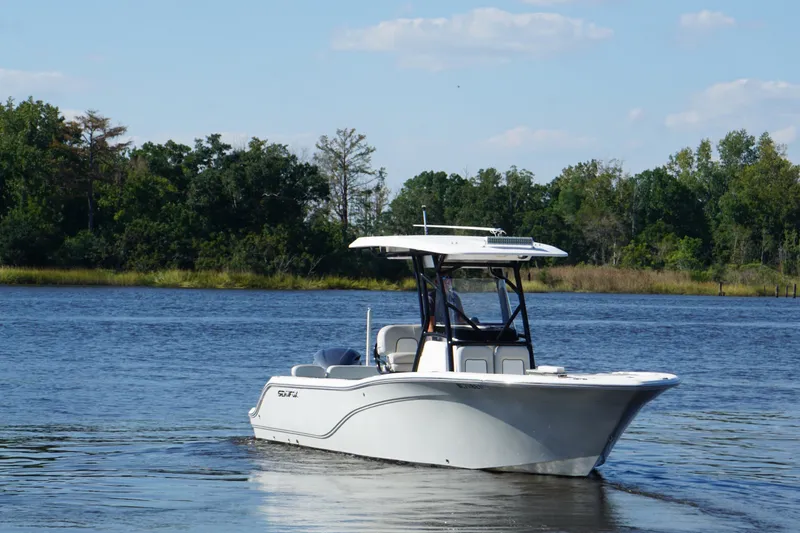 The Image of 2021 Sea Fox 248 Commander boat cruising on a serene lake with lush greenery. - 0