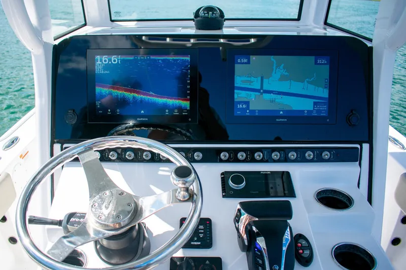 Slide: The Image of Dashboard of 2023 Sportsman Masters 247 Bay Boat with advanced navigation displays. - 16