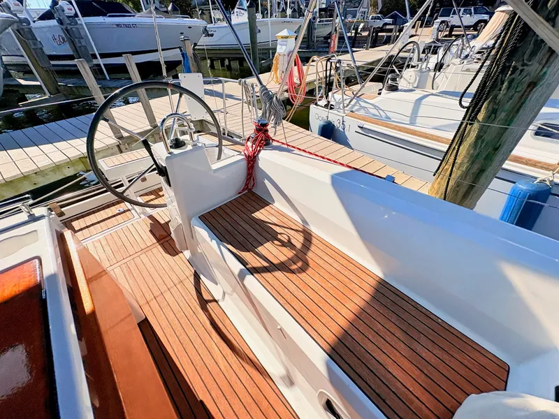 Slide: The Image of The image shows the cockpit of a 2020 Beneteau Oceanis 35.1 with wooden decks and a steering wheel. - 41
