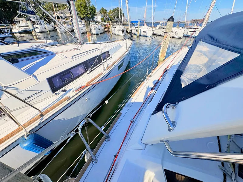 Slide: The Image of Two sailboats are docked side by side in a marina. The water is calm and clear. - 42
