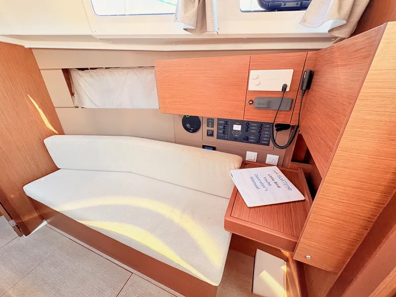 Slide: The Image of Interior of a 2020 Beneteau Oceanis 35.1 with wood paneling and a white sofa. - 20