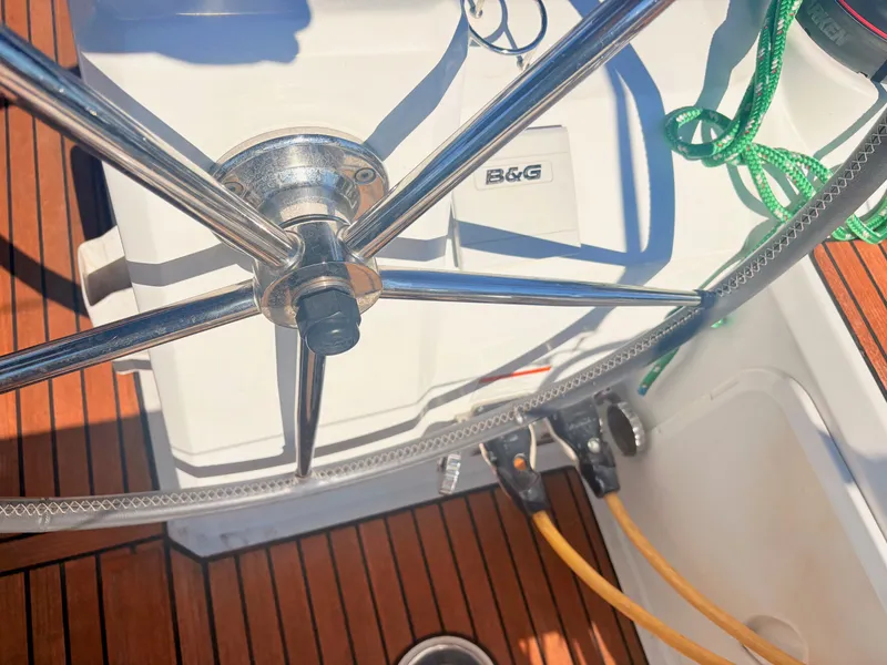 Slide: The Image of The image shows the steering wheel of a Beneteau Oceanis 35.1 with teak decking. - 6
