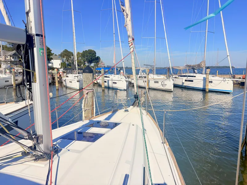 Slide: The Image of A 2020 Beneteau Oceanis 35.1 is docked in a busy marina with several sailboats. - 10