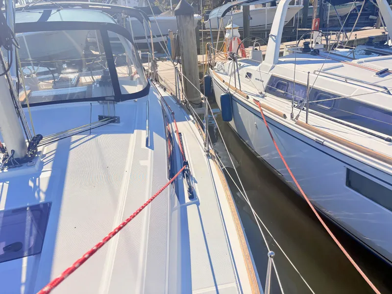 Slide: The Image of Two sailboats are docked side by side. The left boat features a red rope. - 14