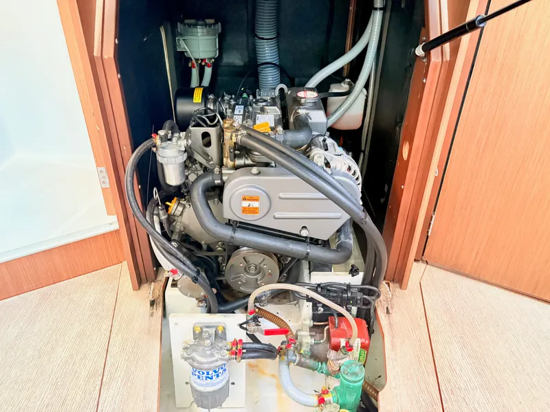 Slide: The Image of The engine compartment of a 2020 Beneteau Oceanis 35.1 shows a well-maintained engine with hoses and fittings. - 45