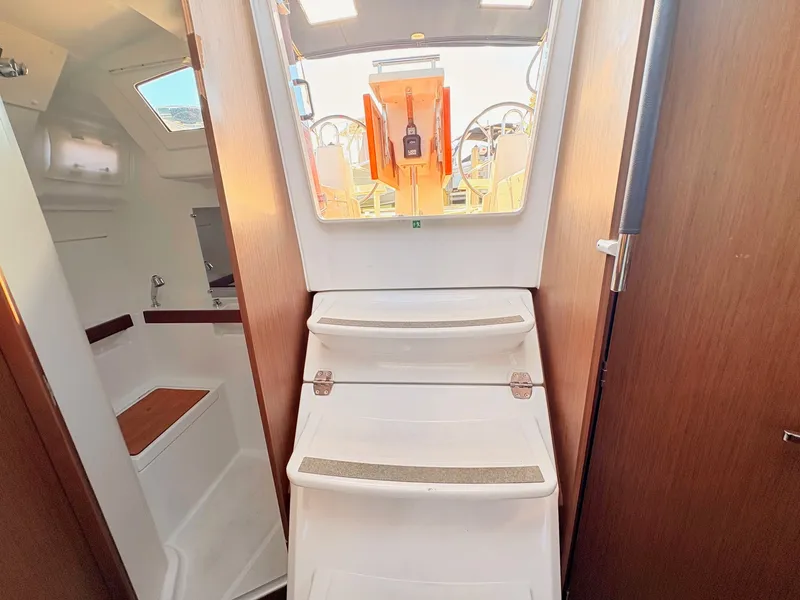 Slide: The Image of Interior view of a Beneteau Oceanis 35.1 with stairs leading to the cabin and light wood decor. - 39