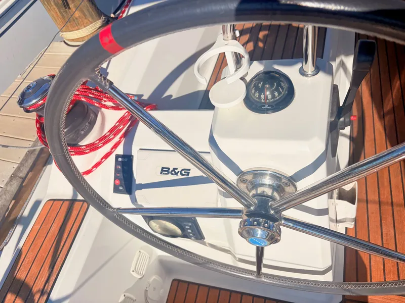 Slide: The Image of The image shows the cockpit of a Beneteau Oceanis 35.1 with a steering wheel and navigation instruments. - 7