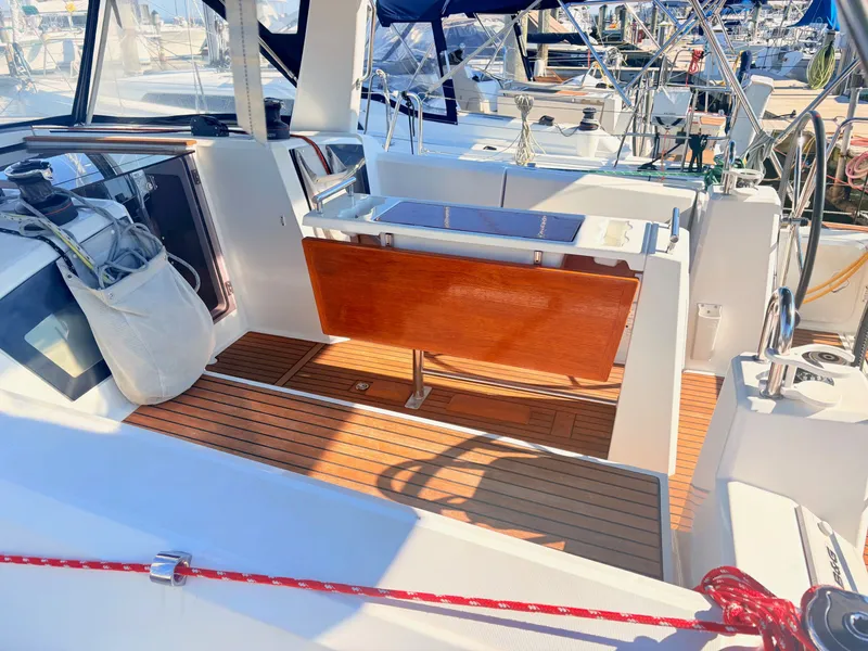 Slide: The Image of The cockpit of a 2020 Beneteau Oceanis 35.1 with wooden flooring and seating area. - 4