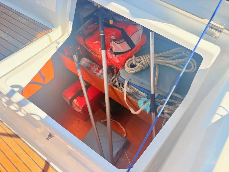 Slide: The Image of A storage compartment on a Beneteau Oceanis 35.1 with life jackets, ropes, and poles. - 8