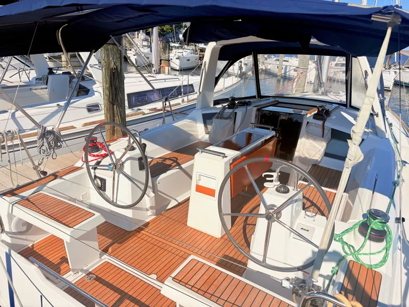 Slide: The Image of The image shows the cockpit of a Beneteau Oceanis 35.1 with dual steering wheels and wooden flooring. - 3