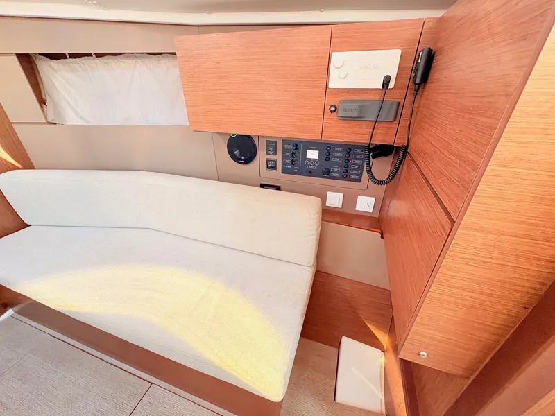 Slide: The Image of Interior of a 2020 Beneteau Oceanis 35.1 with wood paneling and a white sofa. - 21