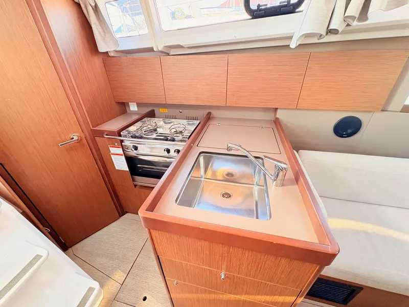 Slide: The Image of The galley of a 2020 Beneteau Oceanis 35.1 with a sink and stove. - 33