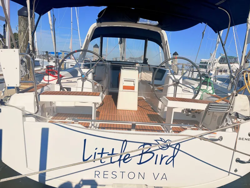 Slide: The Image of The image shows the cockpit of a Beneteau Oceanis 35.1 with dual steering wheels and wooden flooring. - 1