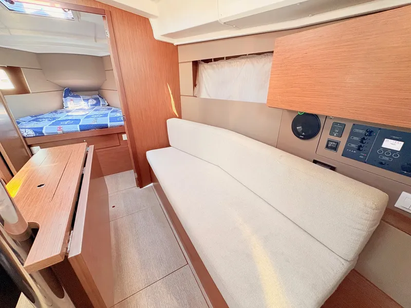 Slide: The Image of Interior of a 2020 Beneteau Oceanis 35.1 featuring a sofa, control panel, and sleeping area. - 23