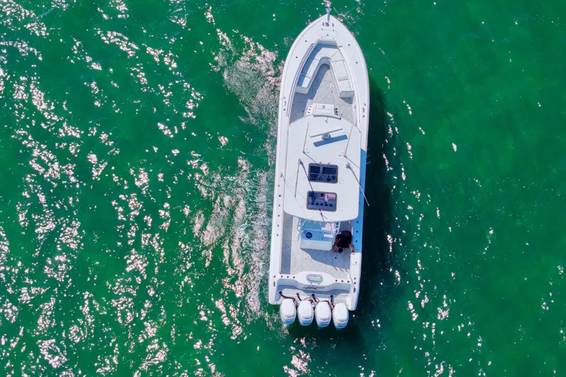 Slide: The Image of Aerial view of 2017 Yellowfin 42 Offshore boat cruising on sparkling green water. - 5
