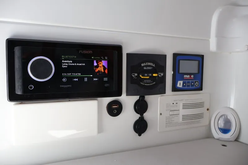 Slide: The Image of 2017 Yellowfin 42 Offshore boat control panel with audio system and navigation controls. - 23