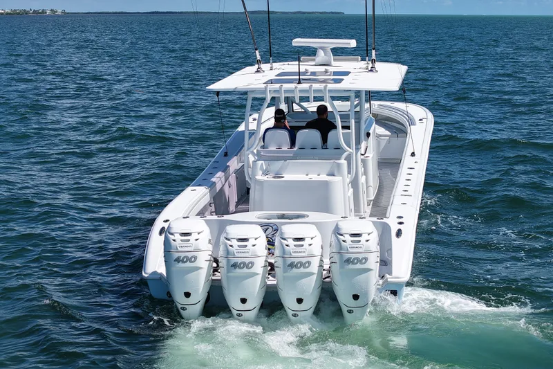 Slide: The Image of 2017 Yellowfin 42 Offshore boat with quad 400 Verado engines cruising on open water. - 2