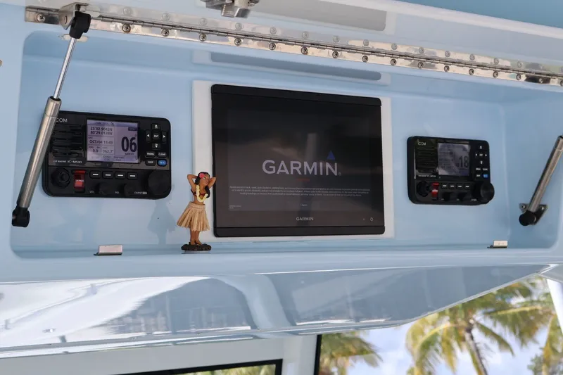 Slide: The Image of 2017 Yellowfin 42 Offshore dashboard with Garmin display and communication devices. - 13