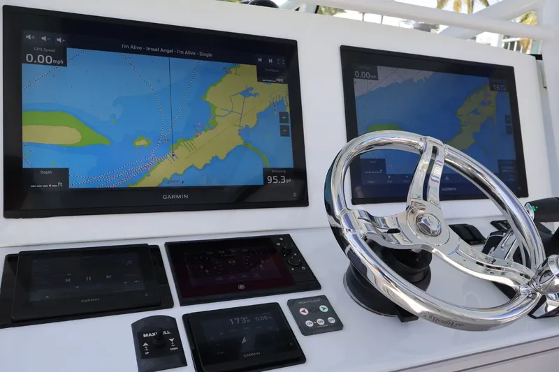 Slide: The Image of Dashboard of a 2017 Yellowfin 42 Offshore boat with Garmin navigation displays. - 12