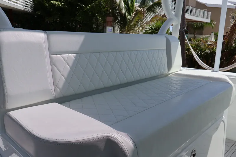 Slide: The Image of Luxurious white seating on 2017 Yellowfin 42 Offshore boat, featuring diamond stitching. - 7