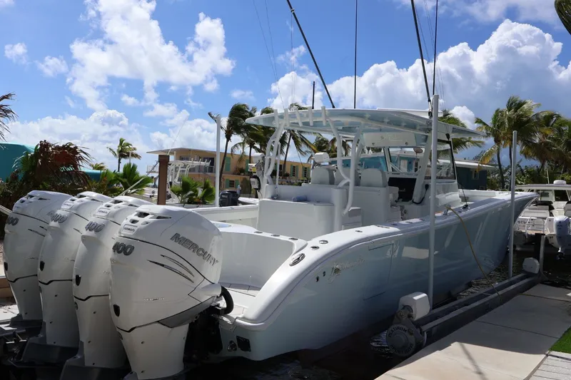Slide: The Image of 2017 Yellowfin 42 Offshore boat with four Mercury 400 engines, docked under a sunny sky. - 34