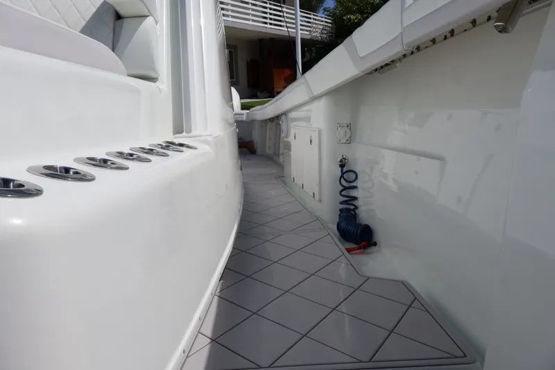 Slide: The Image of 2017 Yellowfin 42 Offshore boat interior with sleek white design and fishing rod holders. - 19