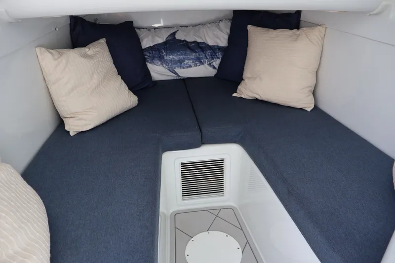 Slide: The Image of Cozy cabin interior of 2017 Yellowfin 42 Offshore with blue cushions and pillows. - 24